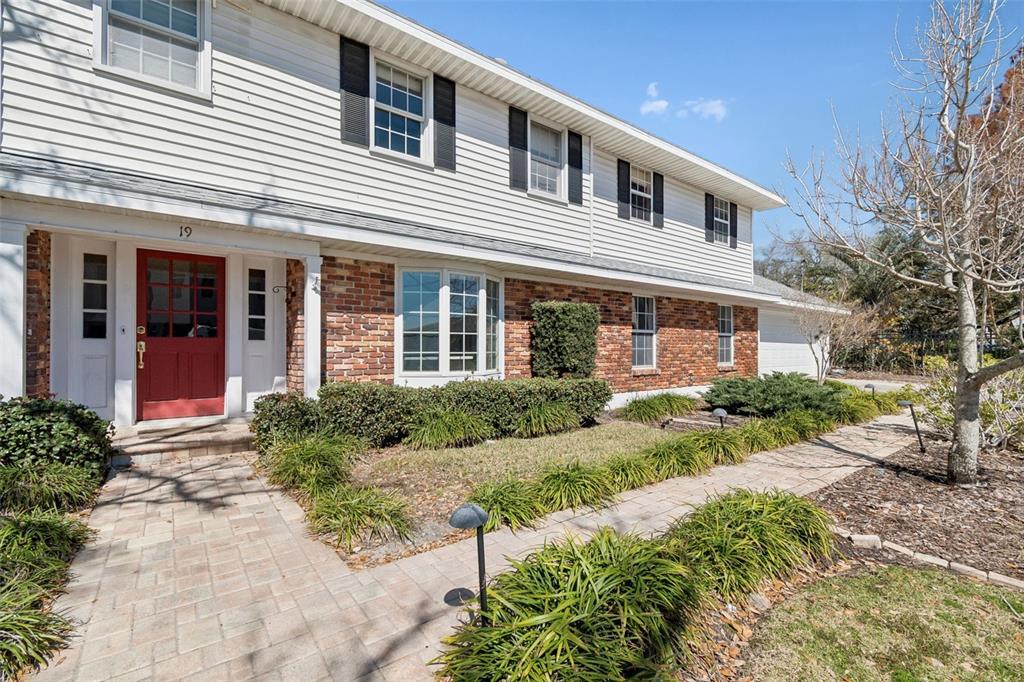 19 Sandpiper Road Tampa, FL 33609 - Photo 4 of 64 a front view of a house with a yard and potted plants