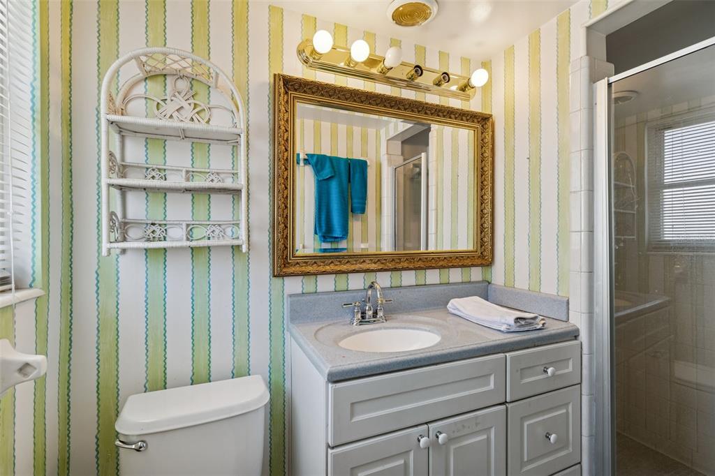 19 Sandpiper Road Tampa, FL 33609 - Photo 47 of 64 a bathroom with a granite countertop sink a toilet and a mirror