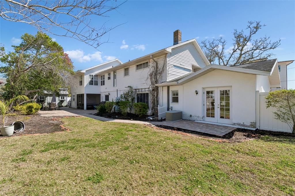 19 Sandpiper Road Tampa, FL 33609 - Photo 52 of 64 a front view of a house with a yard and garage