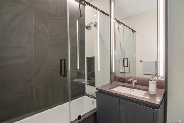 a bathroom with a sink and mirror