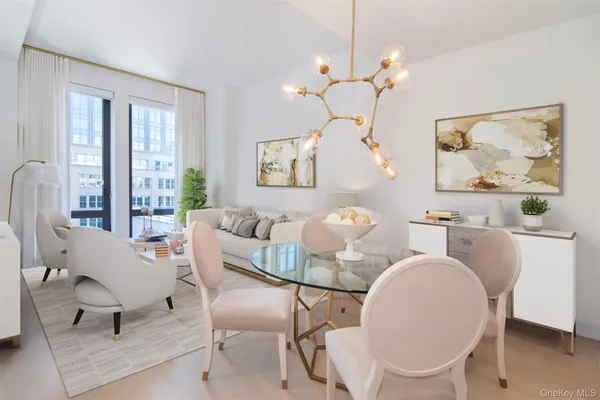 a dining room with wooden floor a chandelier a glass table and chairs