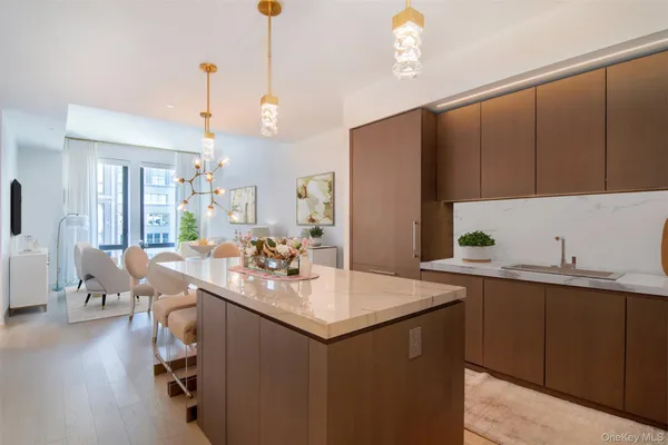 a kitchen with a sink dishwasher and a refrigerator with wooden floor
