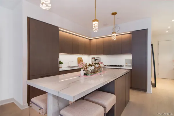 a kitchen with a sink a counter space and stainless steel appliances