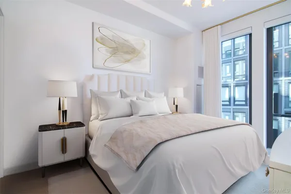 a spacious bedroom with a bed and a painting on the wall