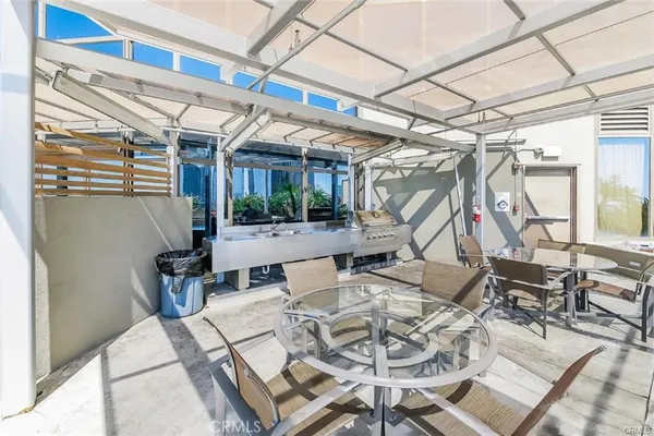 a view of a patio with table and chairs