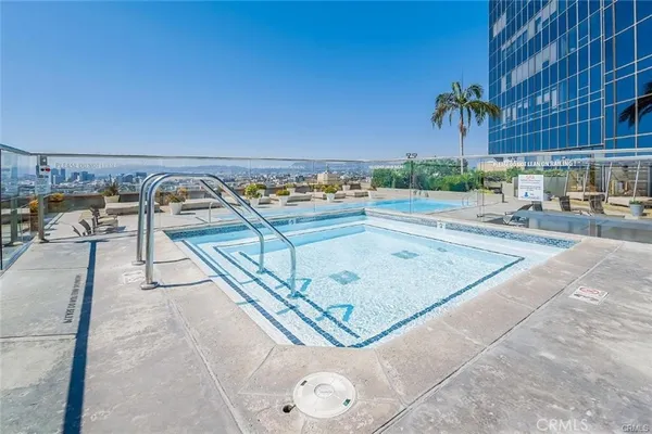 swimming pool view with a outdoor seating space