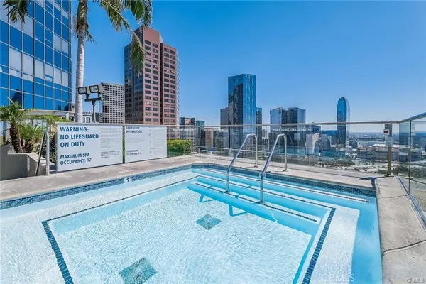 a view of swimming pool with outdoor seating and city view