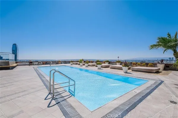 a view of a swimming pool and an outdoor seating