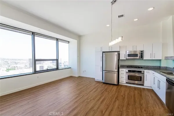 a kitchen with a stove a refrigerator and a sink