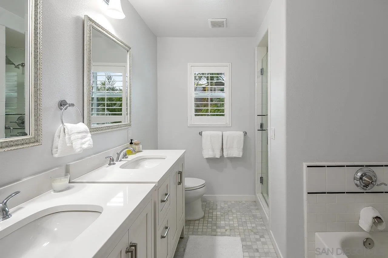 1258 Oak Avenue Carlsbad, CA 92008 - Photo 10 of 29 a bathroom with a granite countertop sink mirror and a toilet