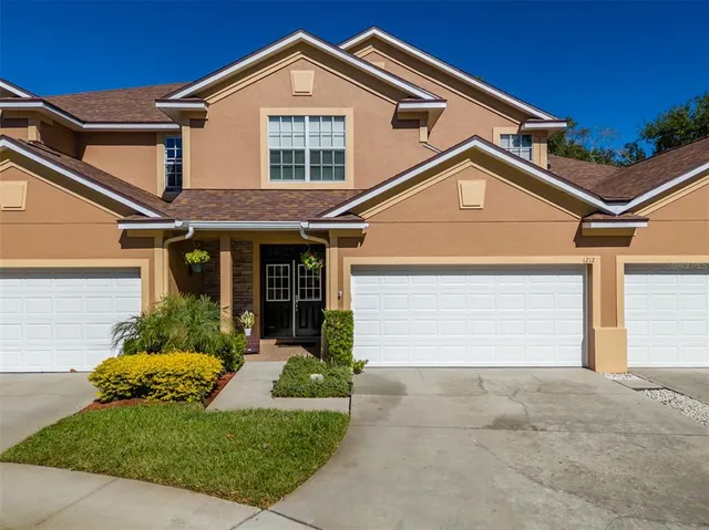a front view of a house with a yard and garage