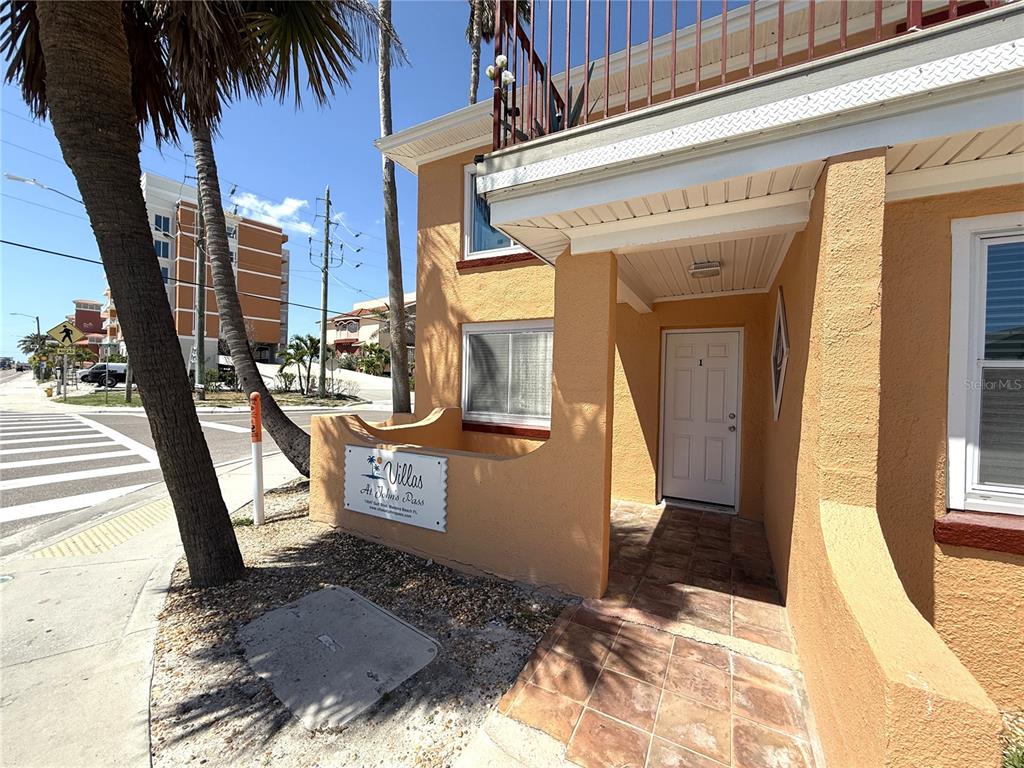 a view of a porch with furniture and floor to ceiling window