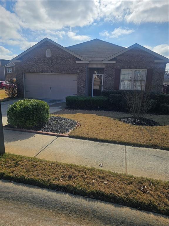 1738 Blue Heron Way Hampton, GA 30228 - Photo 5 of 36 a front view of a house with a yard and garage