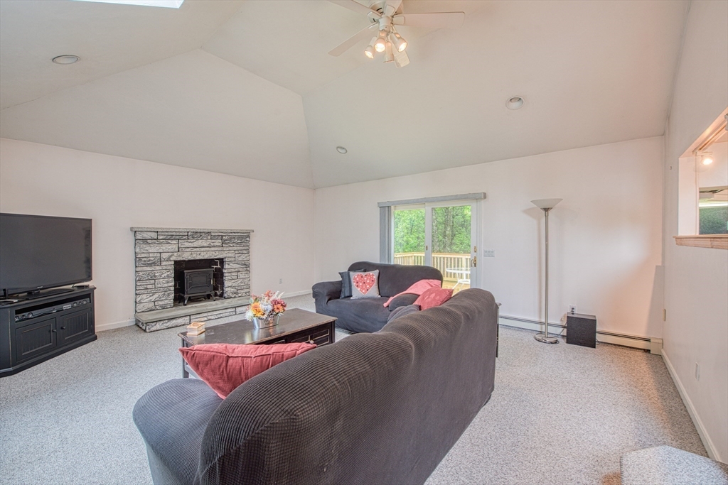 7 Tisdale Road Sharon, MA 02067 - Photo 6 of 37 a living room with furniture a fireplace and a flat screen tv