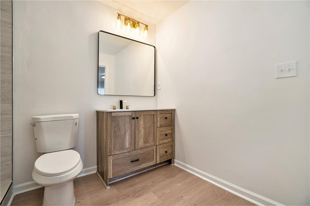 2901 Lenox Road Northeast, Unit 901 Atlanta, GA 30324 - Photo 11 of 18 a bathroom with a toilet sink and mirror