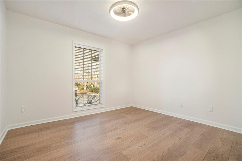 2901 Lenox Road Northeast, Unit 901 Atlanta, GA 30324 - Photo 13 of 18 an empty room with wooden floor and windows