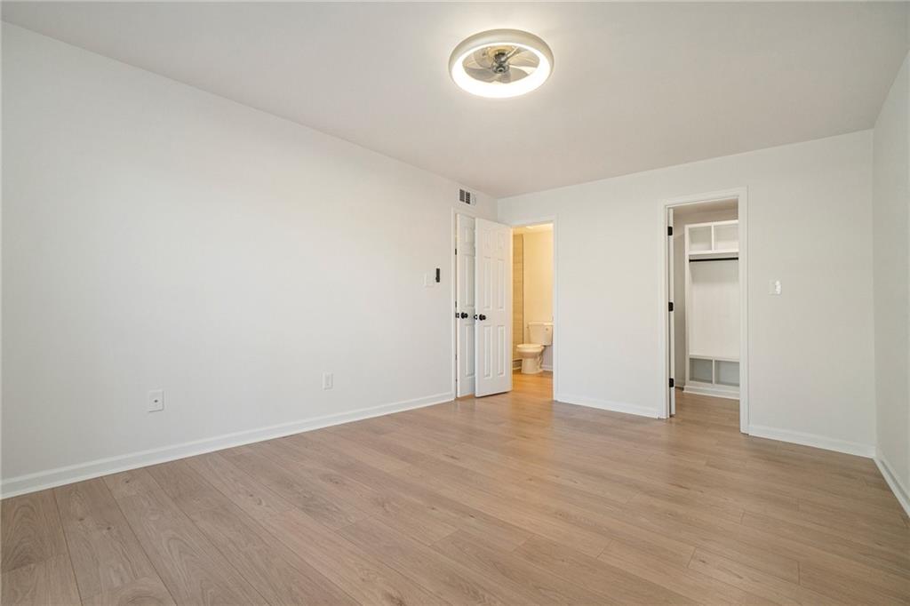 2901 Lenox Road Northeast, Unit 901 Atlanta, GA 30324 - Photo 10 of 18 a view of an empty room with wooden floor