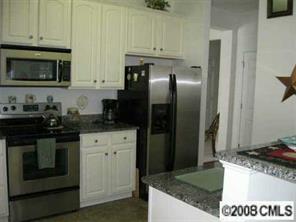 1033 Peridot Court Fort Mill, SC 29708 - Photo 3 of 8 a kitchen with stainless steel appliances granite countertop a stove a refrigerator and a microwave