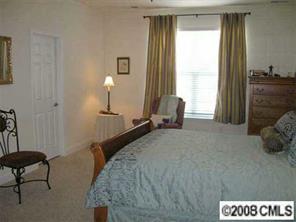 1033 Peridot Court Fort Mill, SC 29708 - Photo 6 of 8 a bedroom with a bed and a chandelier