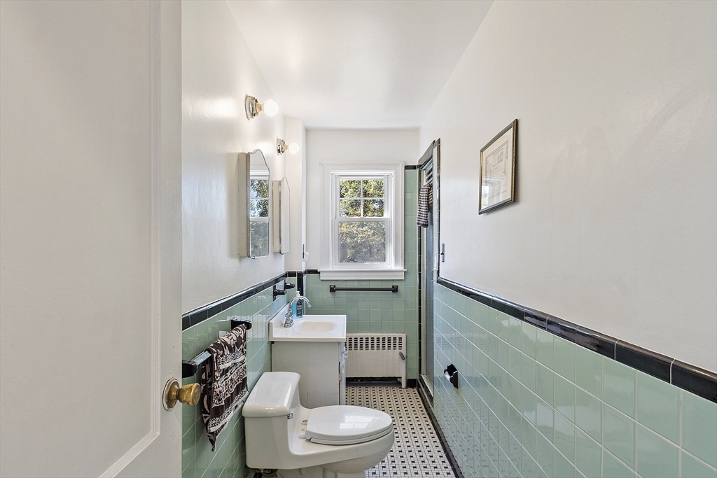 256 Massasoit Road Worcester, MA 01604 - Photo 18 of 33 a bathroom with a sink a toilet a mirror and shower