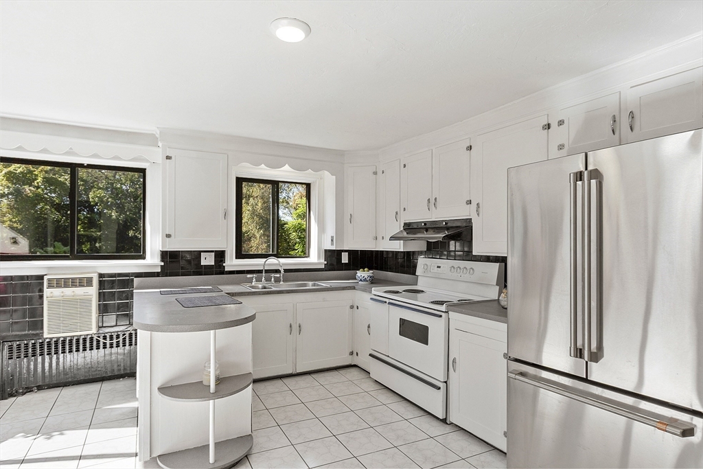 256 Massasoit Road Worcester, MA 01604 - Photo 22 of 33 a kitchen with white cabinets appliances and windows
