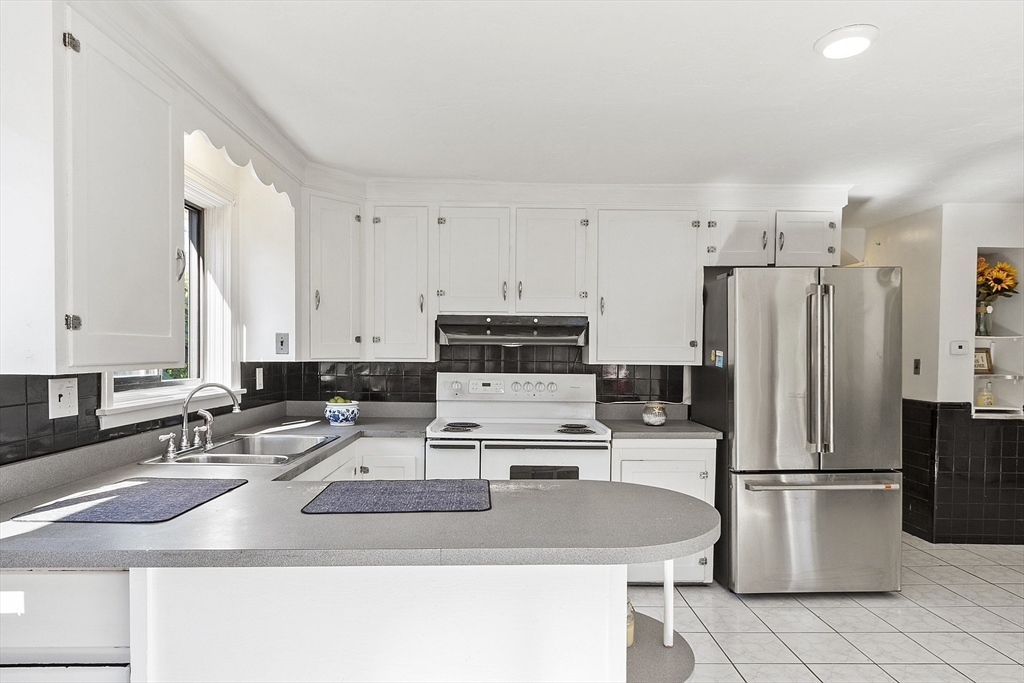 256 Massasoit Road Worcester, MA 01604 - Photo 23 of 33 a kitchen with kitchen island a counter top space appliances and cabinets