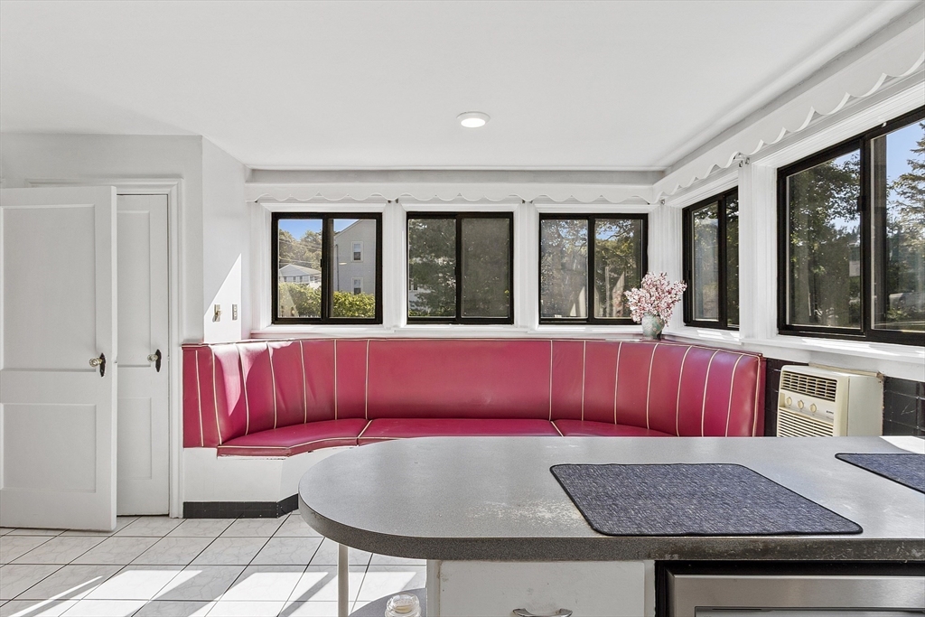 256 Massasoit Road Worcester, MA 01604 - Photo 24 of 33 a living room with a couch and a dining table with wooden floor