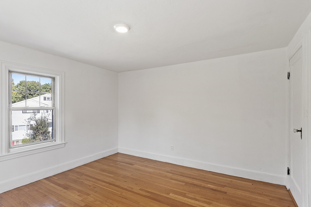 256 Massasoit Road Worcester, MA 01604 - Photo 29 of 33 a view of an empty room with wooden floor and a window