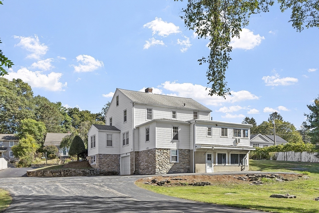 256 Massasoit Road Worcester, MA 01604 - Photo 8 of 33 a front view of a house with a garden and tree