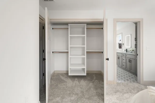 an empty room with windows and closet