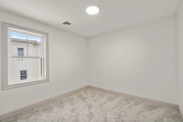 a bathroom with a granite countertop sink mirror and a toilet