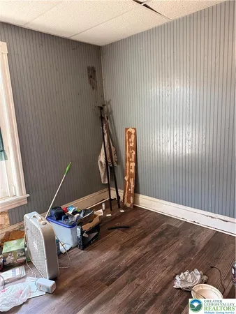a living room with furniture wooden floor and a window