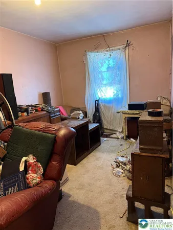 a room with furniture a flat screen tv and a window