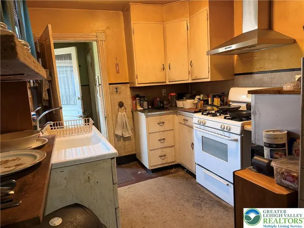 a kitchen that has a sink and a stove