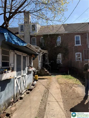 a view of a house with chairs in the patio