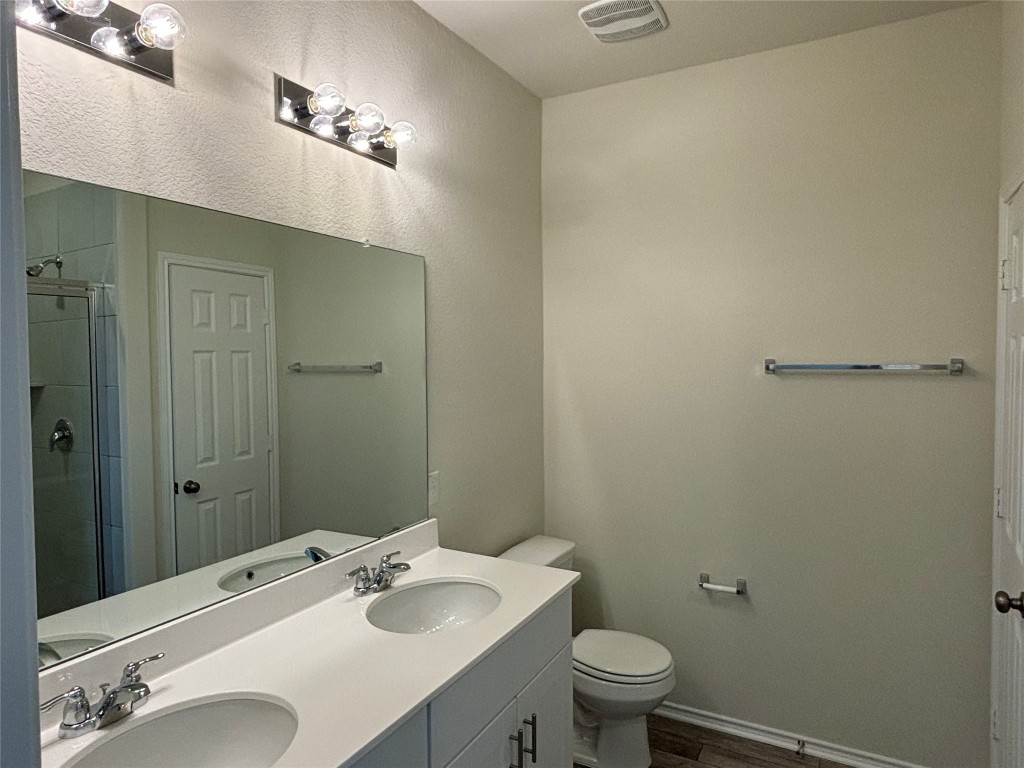 344 Tree Nut Loop Buda, TX 78610 - Photo 14 of 22 a bathroom with a sink toilet and shower