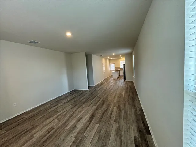 a view of a room with wooden floor