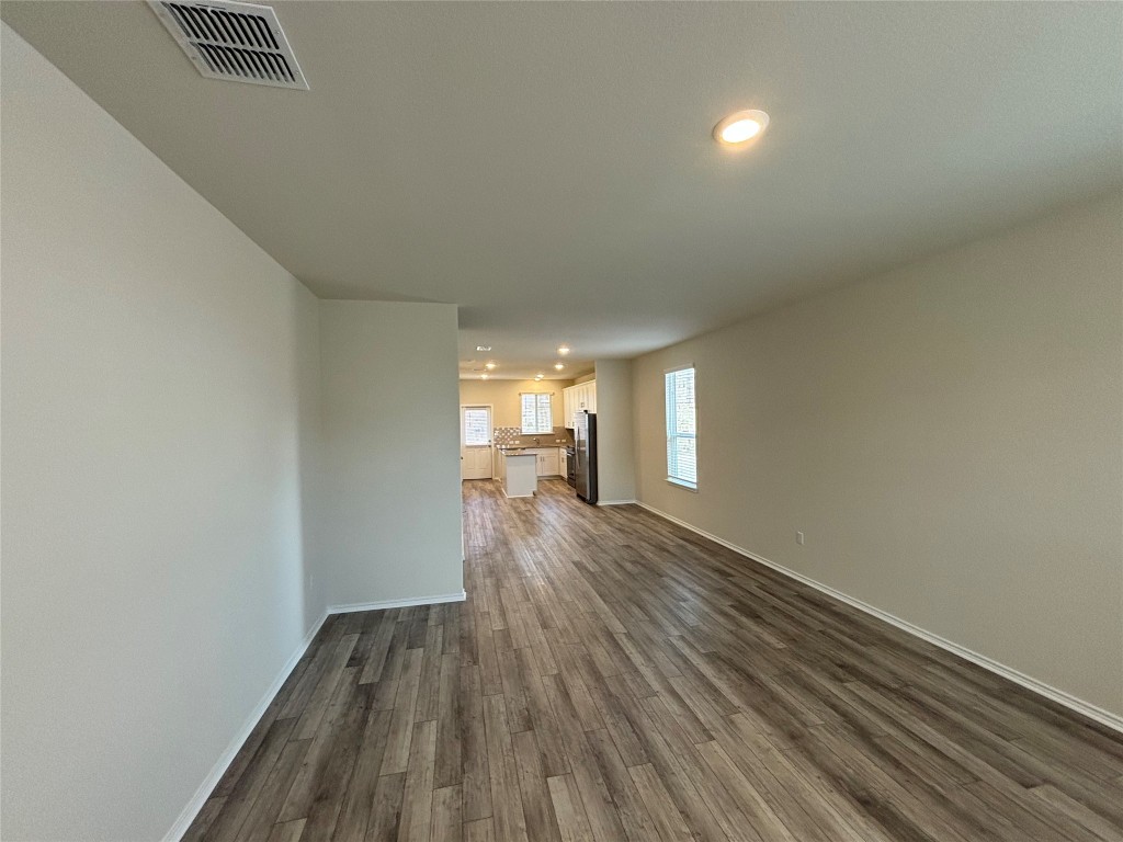 344 Tree Nut Loop Buda, TX 78610 - Photo 8 of 22 a view of a room with wooden floor and a window