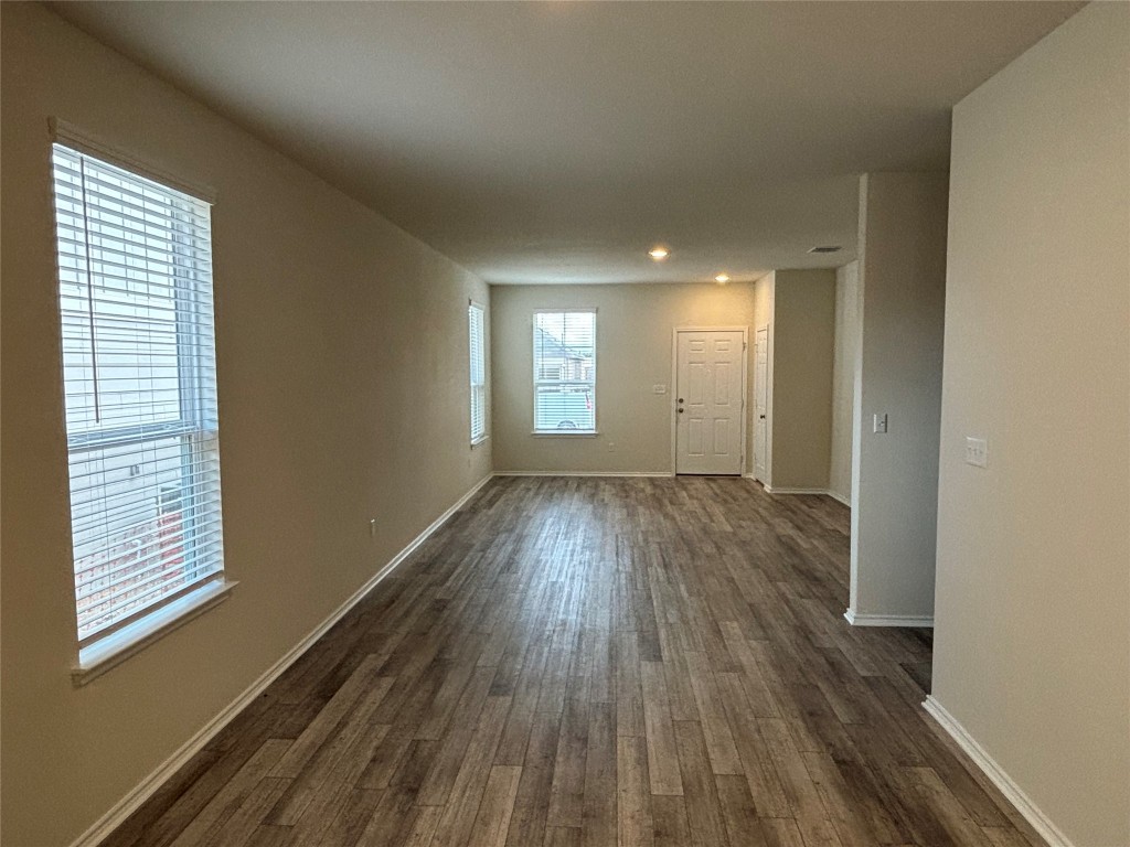 344 Tree Nut Loop Buda, TX 78610 - Photo 10 of 22 a view of wooden floor and windows in a room
