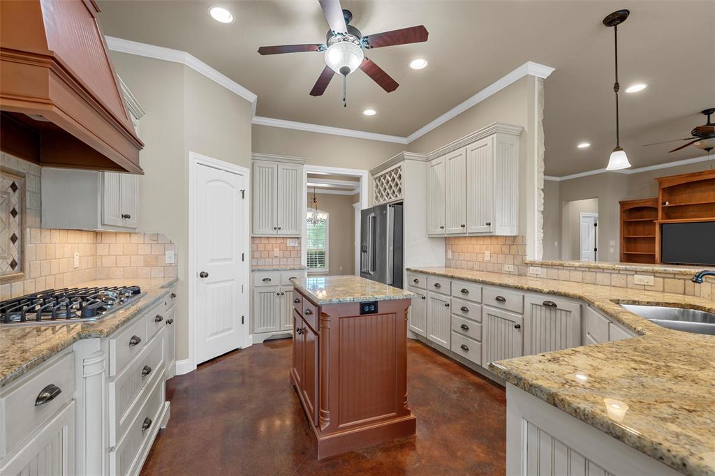 504 Casa Del Rancho Road Lorena, TX 76655 - Photo 11 of 39 a kitchen with granite countertop cabinets a sink a window and stainless steel appliances
