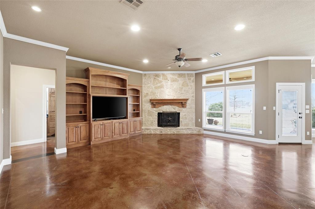 504 Casa Del Rancho Road Lorena, TX 76655 - Photo 4 of 39 an empty room with windows fireplace and a microwave