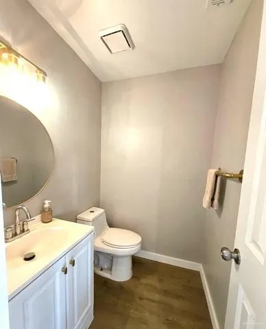 a view of hallway with wooden floor and windows