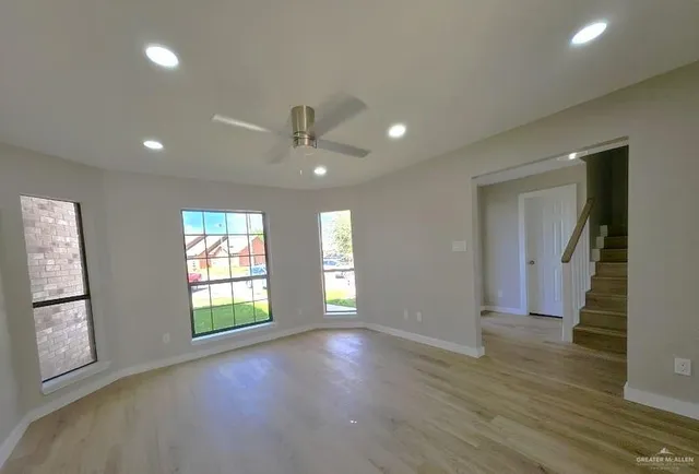 a kitchen with white cabinets and refrigerator