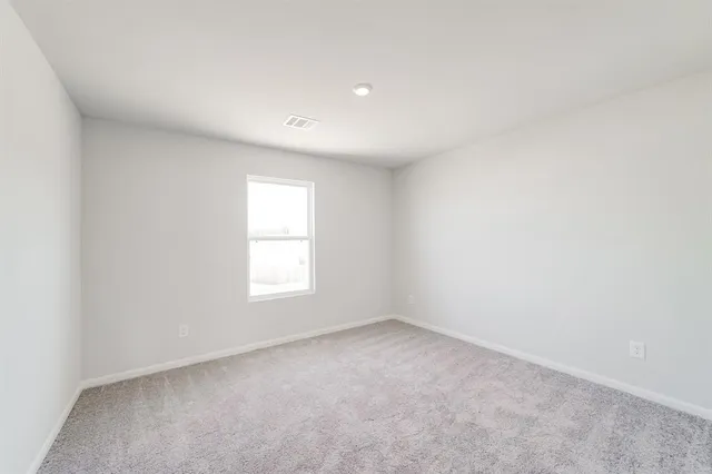 an empty room with closet area