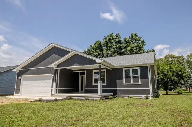 a front view of a house with a yard