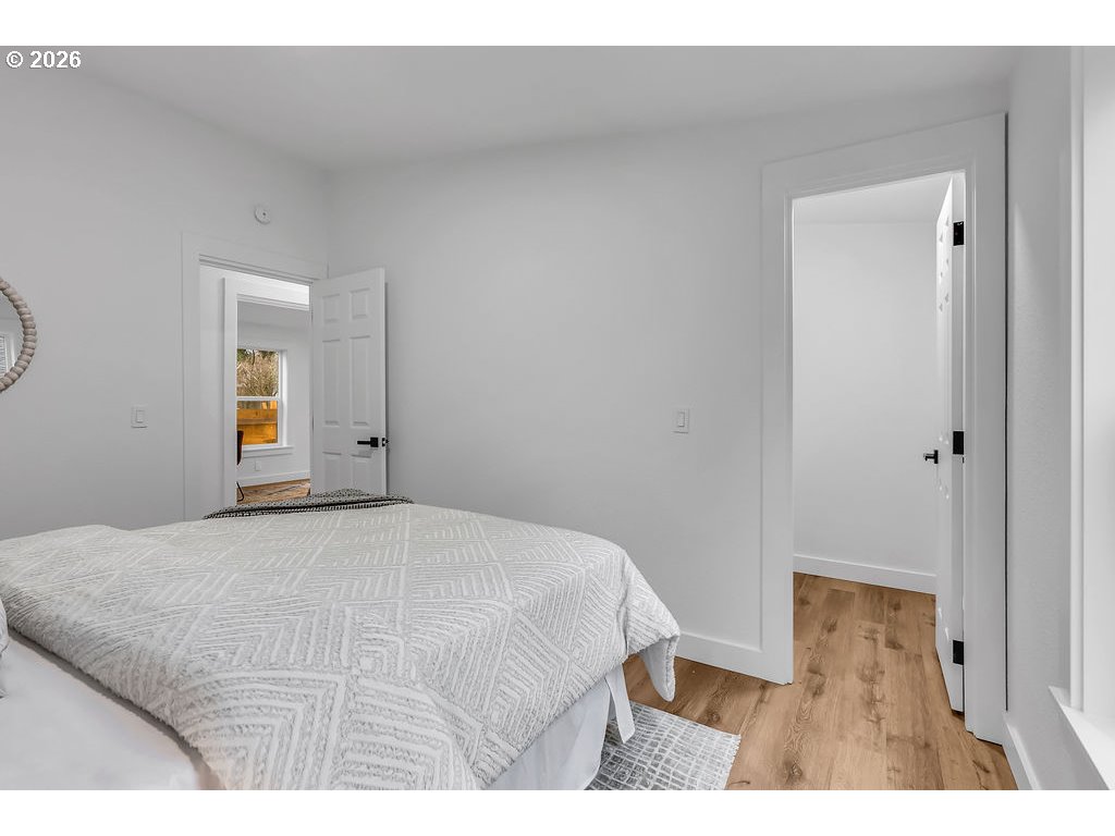 241 Northwest Wade Street Estacada, OR 97023 - Photo 35 of 45 a bedroom with a bed and a night stand