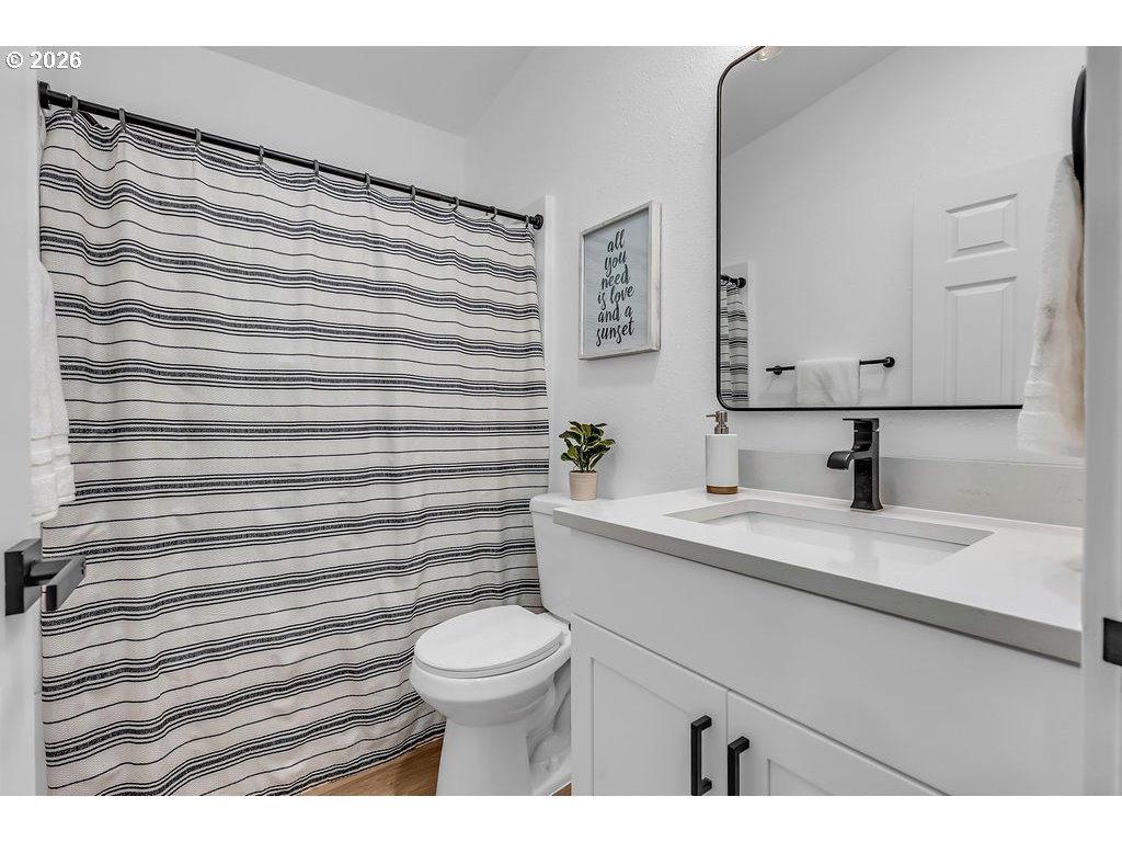 241 Northwest Wade Street Estacada, OR 97023 - Photo 36 of 45 a bathroom with a sink a toilet and mirror