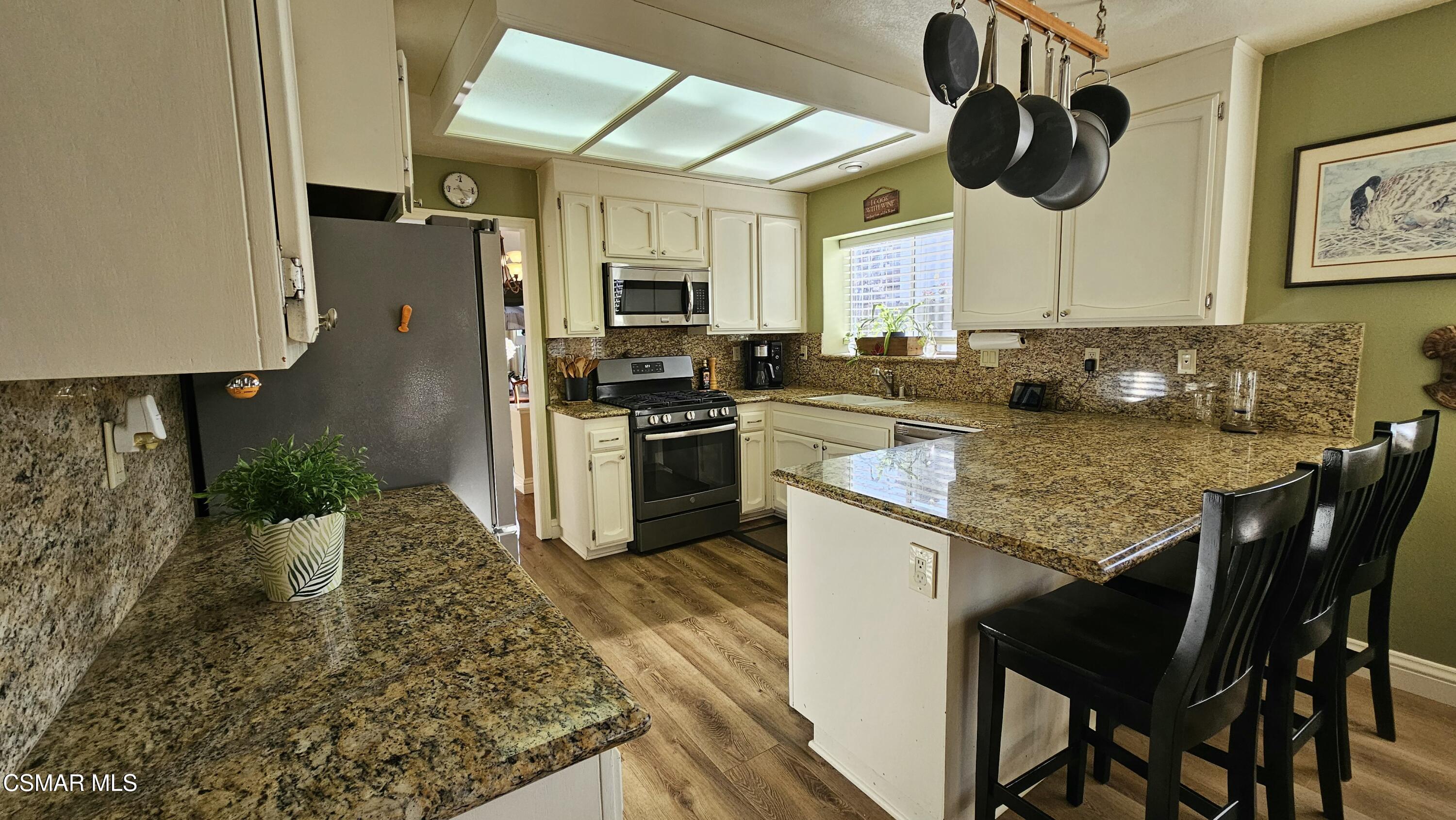 14640 Marymount Street Moorpark, CA 93021 - Photo 15 of 33 a kitchen with a stove a sink and a refrigerator