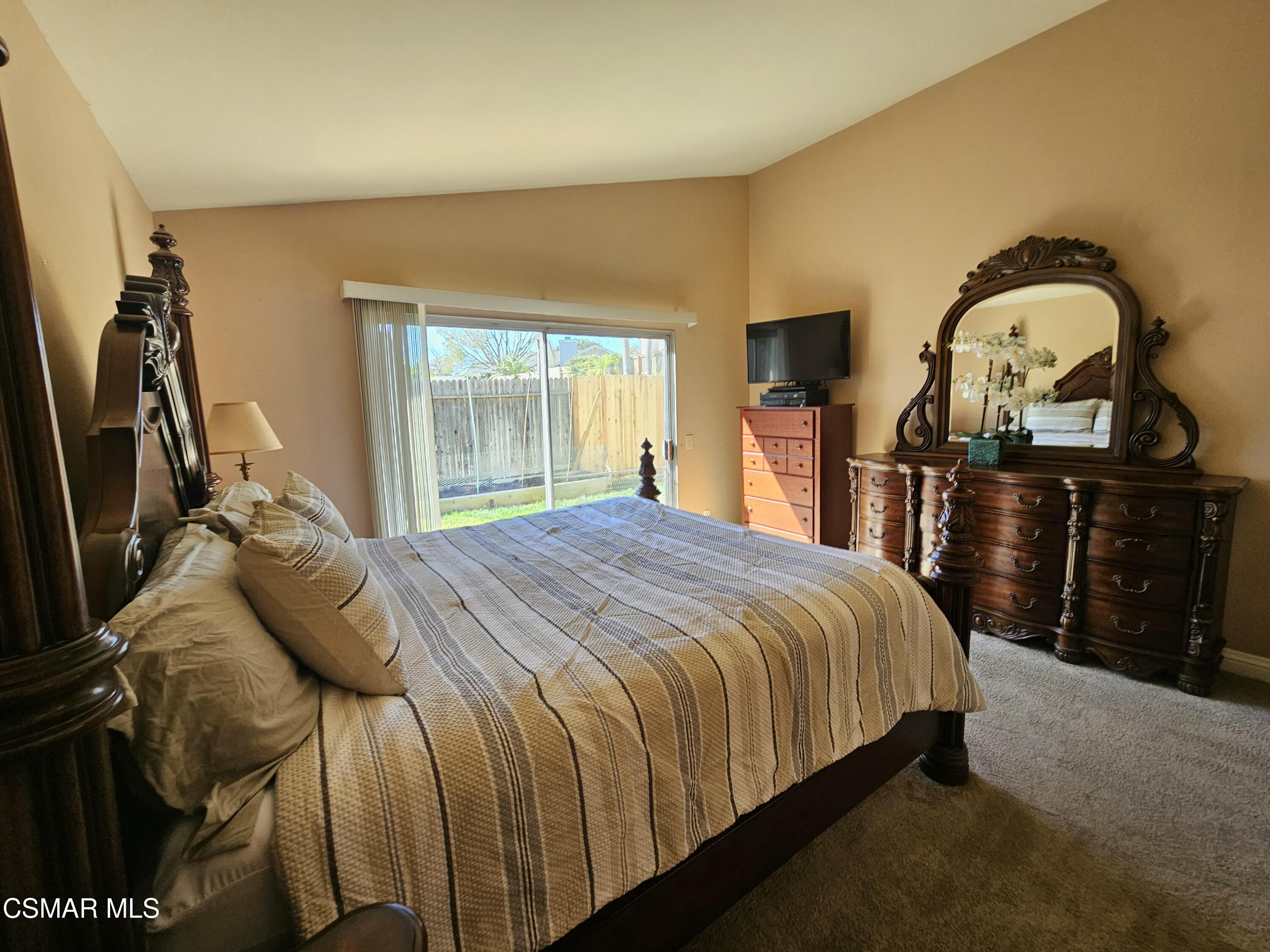 14640 Marymount Street Moorpark, CA 93021 - Photo 21 of 33 a bedroom with a bed and a flat screen tv