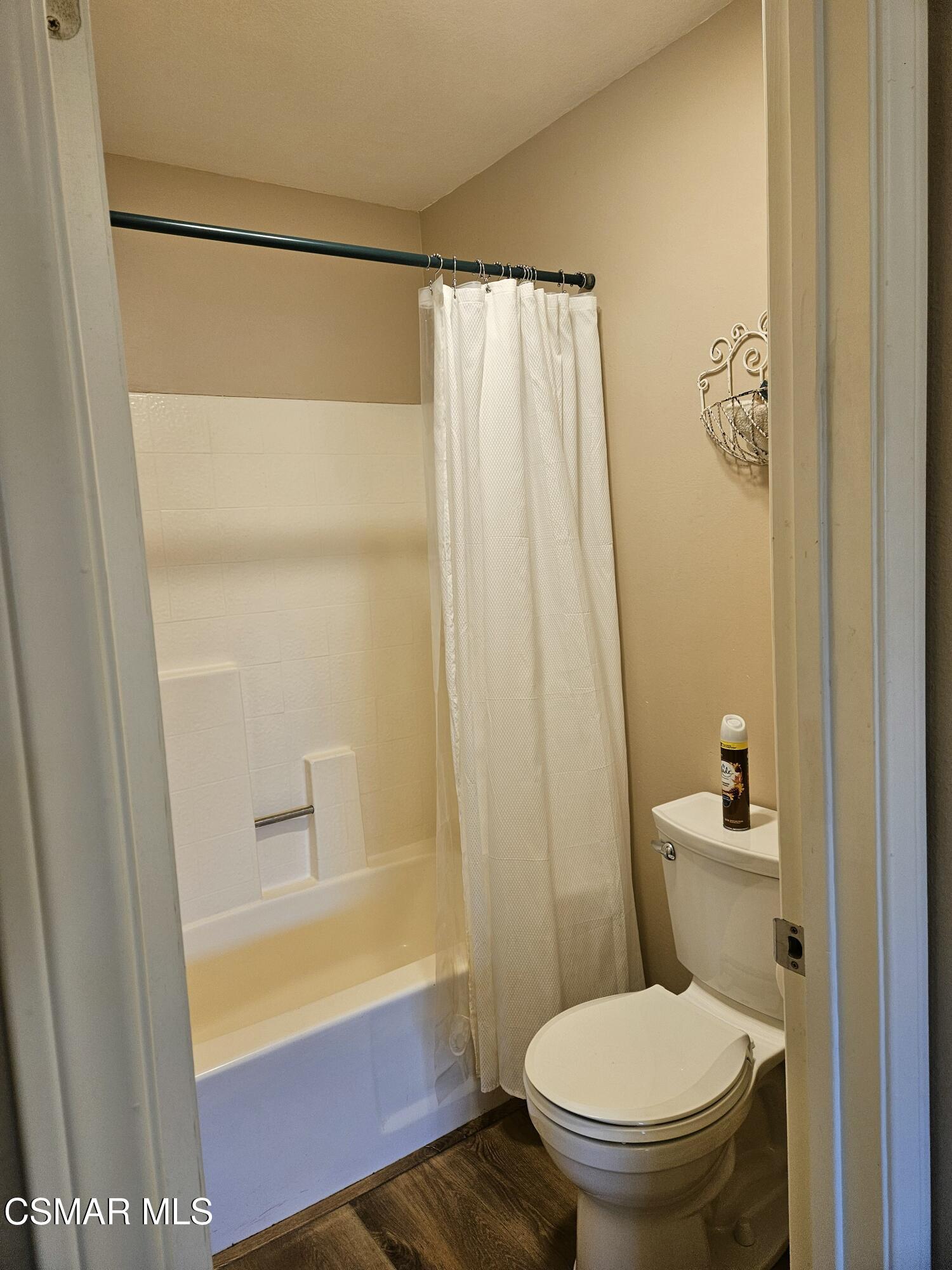 14640 Marymount Street Moorpark, CA 93021 - Photo 24 of 33 a bathroom with a toilet and a shower curtain